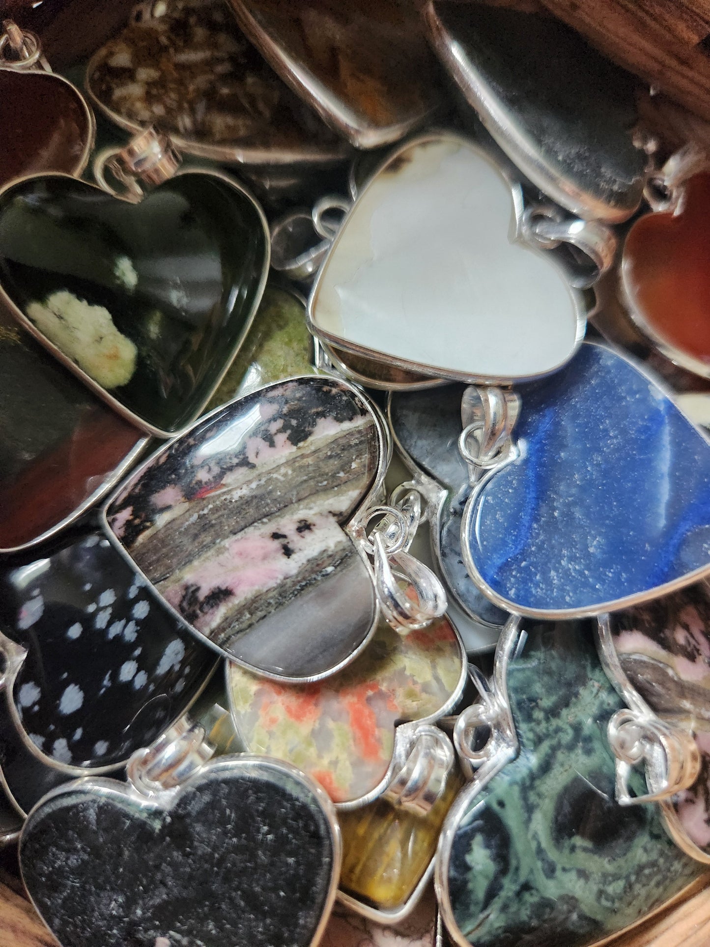 Collection of silver plated heart shaped pendant with various stone inlays