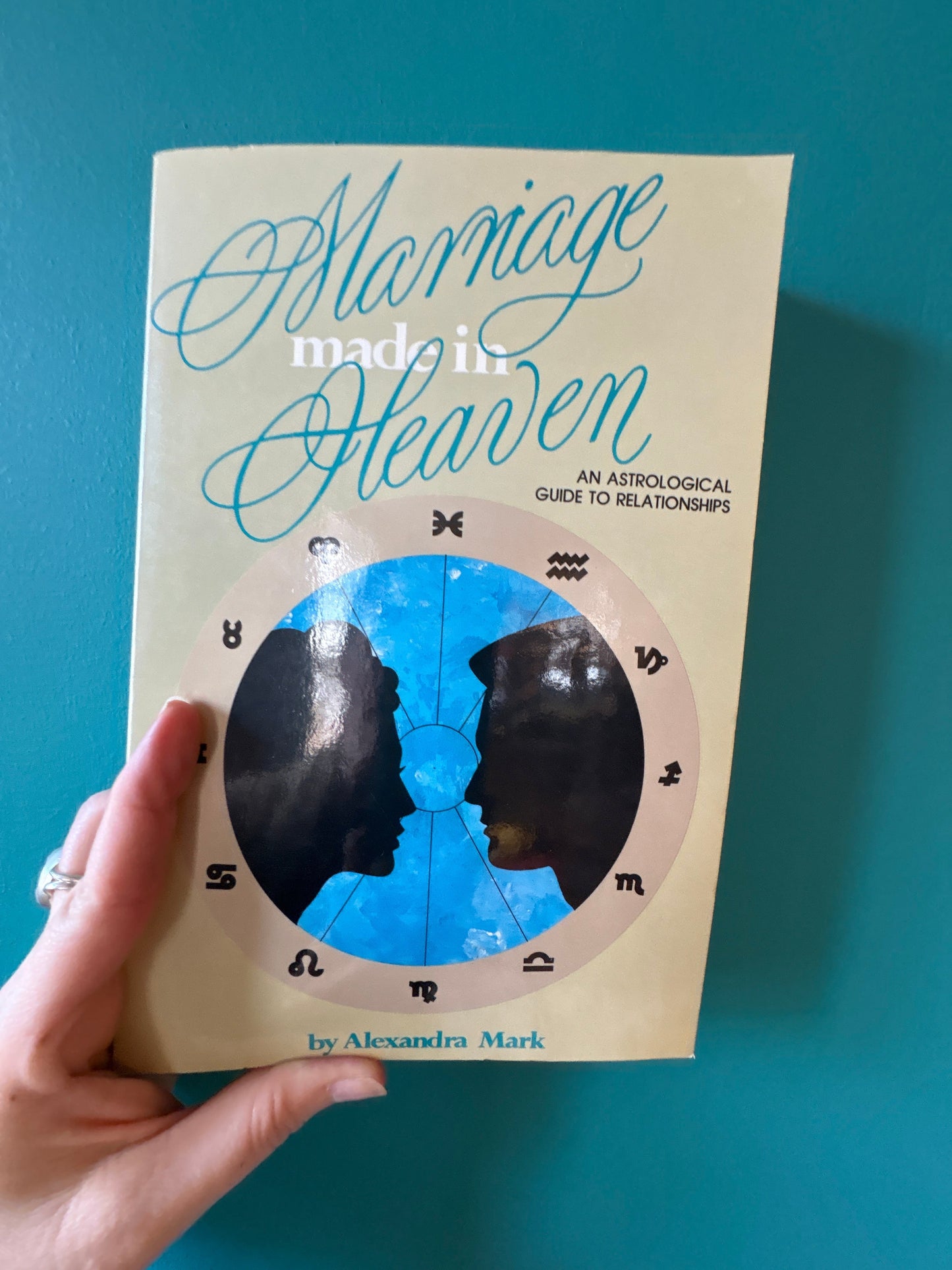 Marriage Made in Heaven book cover featuring astrological relationship guide with zodiac signs and silhouettes of a couple
