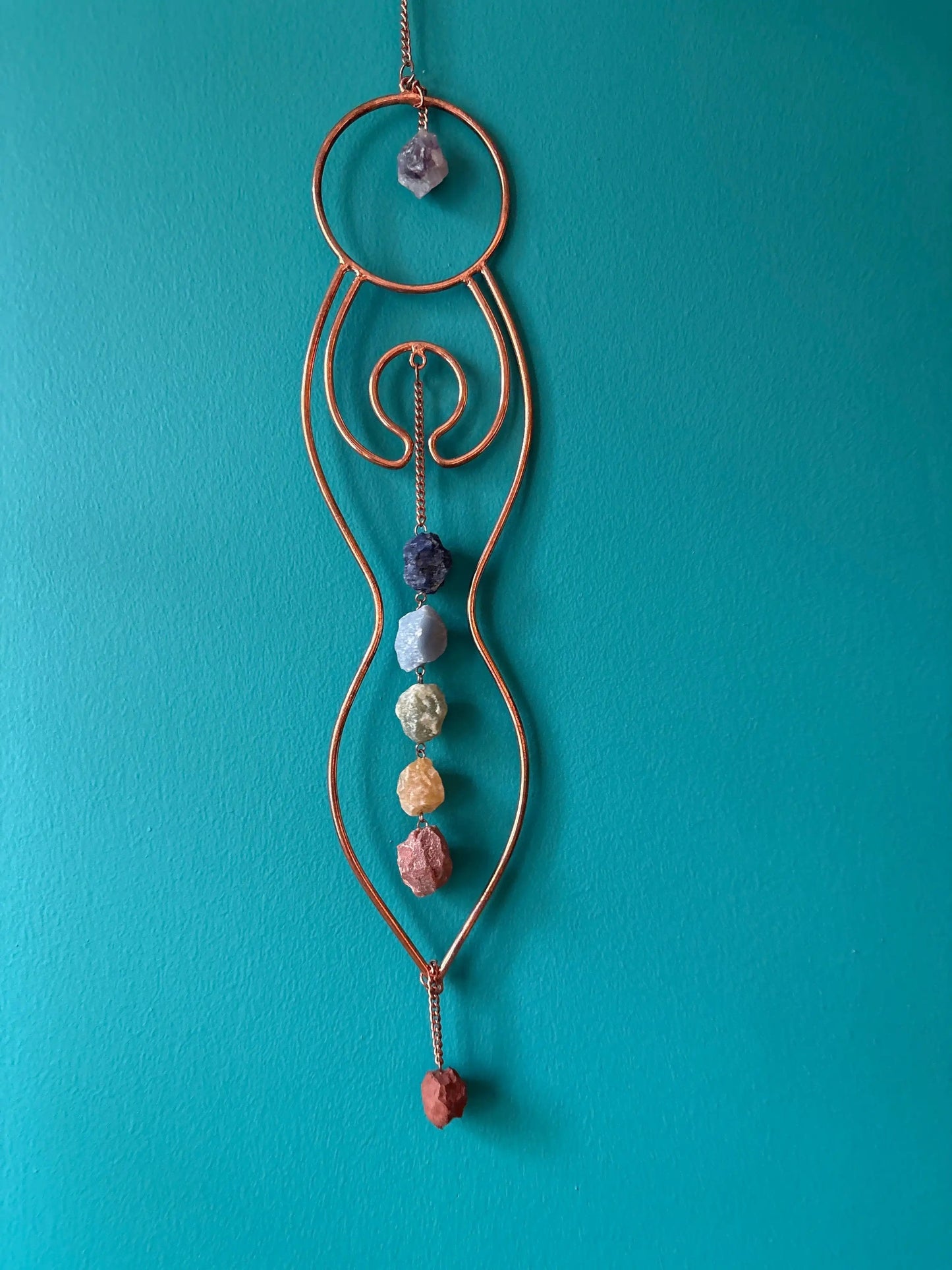 Copper Goddess Chakra stone hanger wall hanging with seven chakra stones on teal background