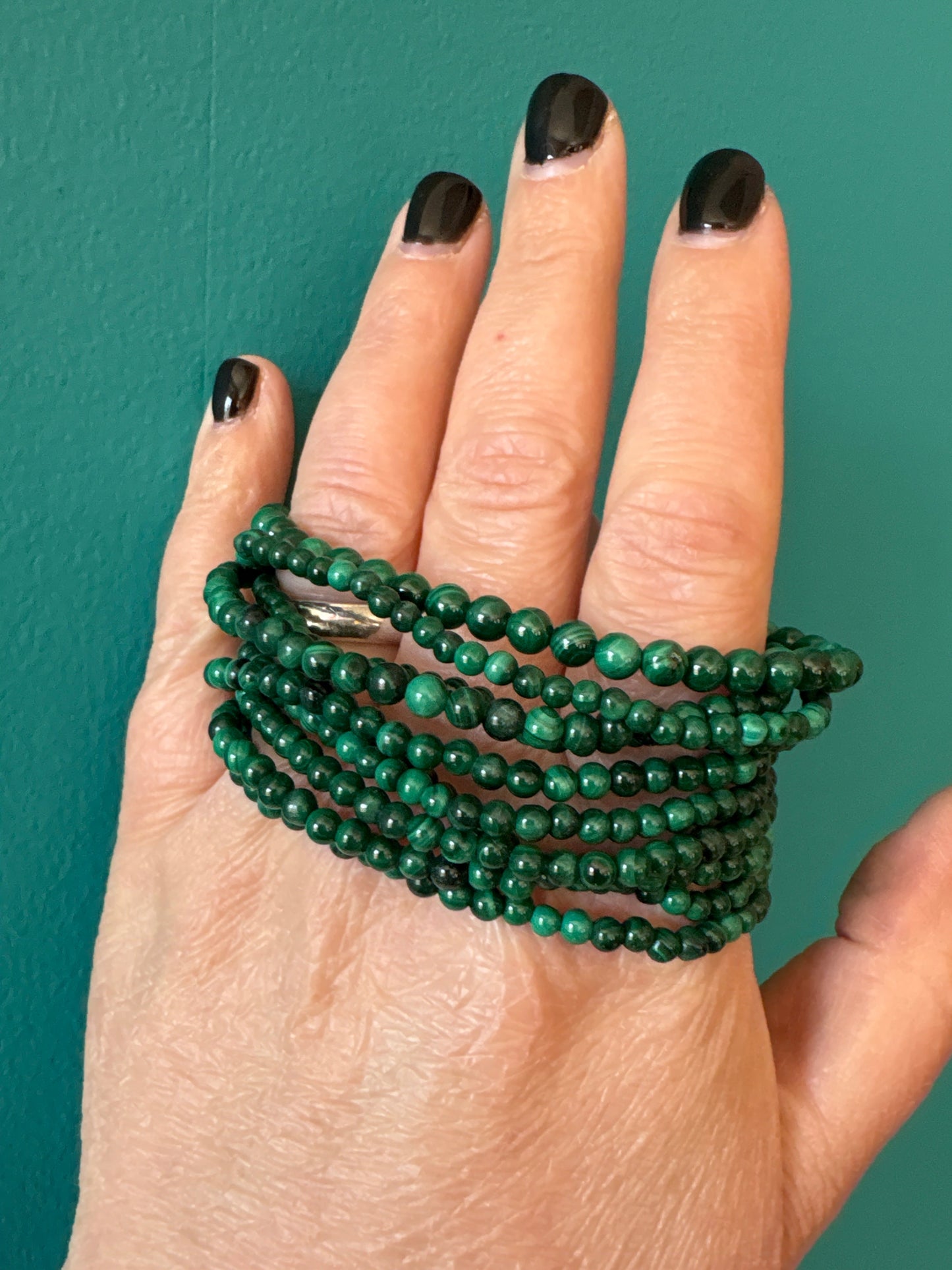 Bracelet Malachite 4mm green stone beads wrapped around hand with black nail polish