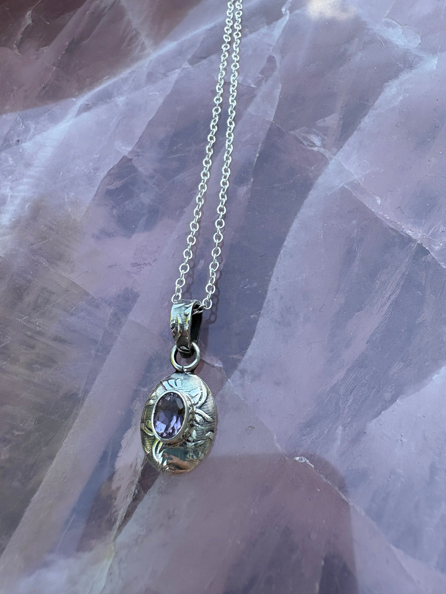 Sterling silver engraved pendant with oval amethyst gemstone on a silver chain