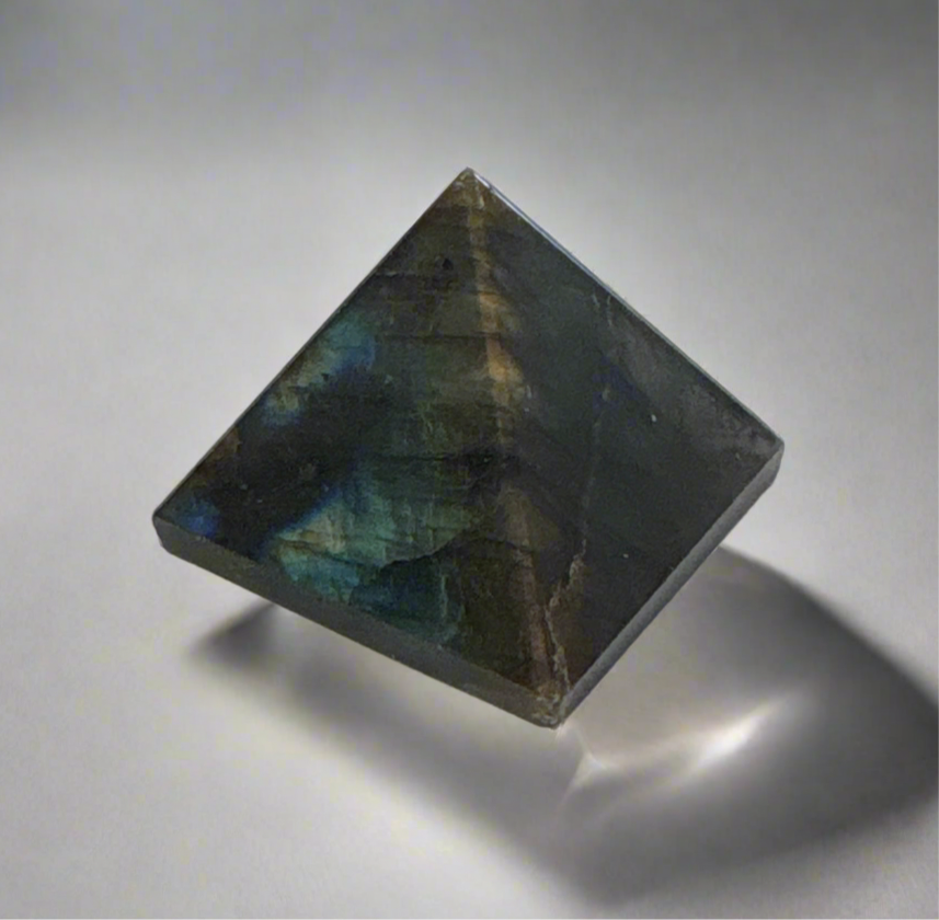 Assorted 25-30mm pyramid crystal with iridescent dark colors promoting balance and clarity