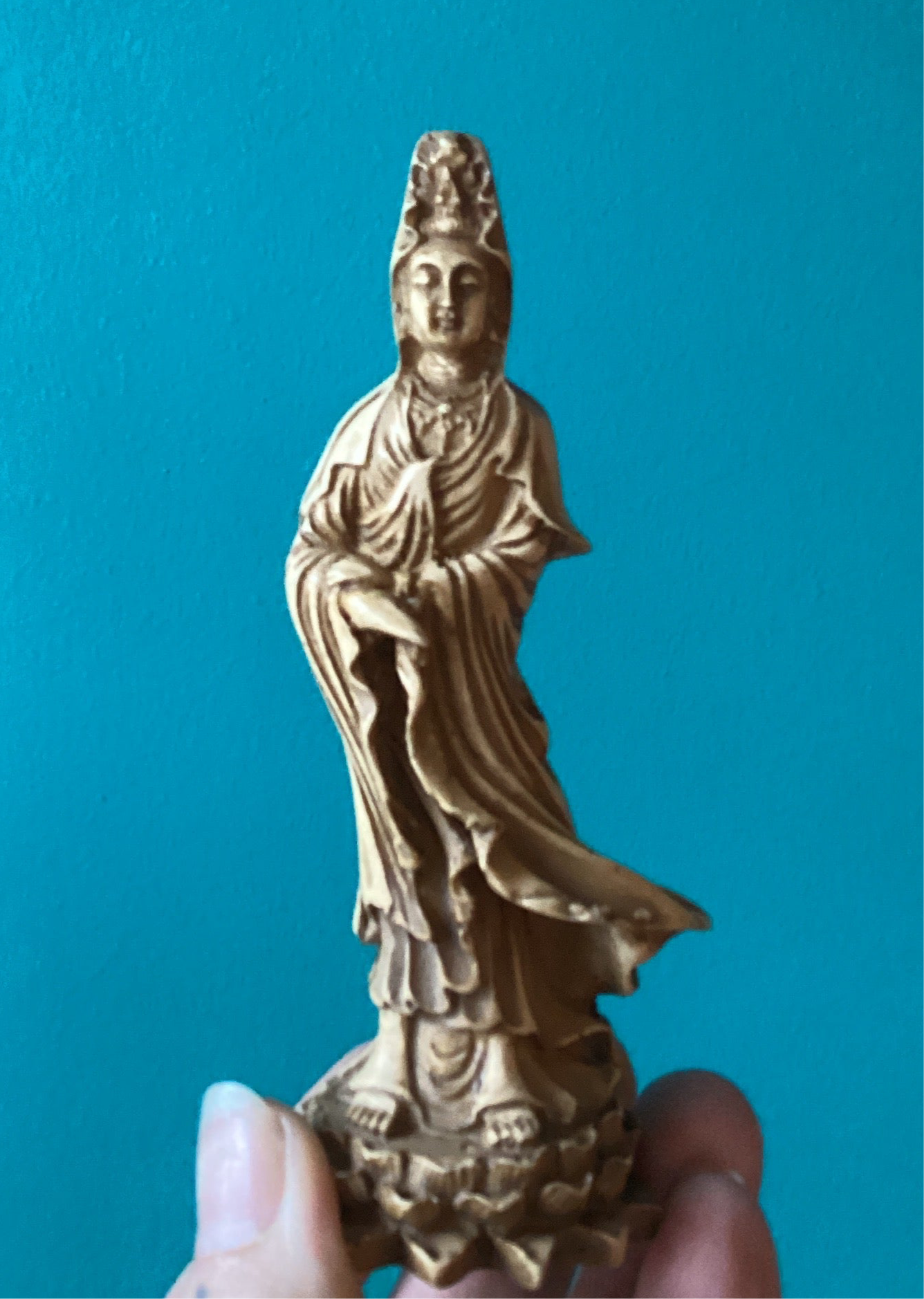 Natural 5.25-inch Kwan Yin Statue depicting the compassionate goddess on a lotus base against a blue background