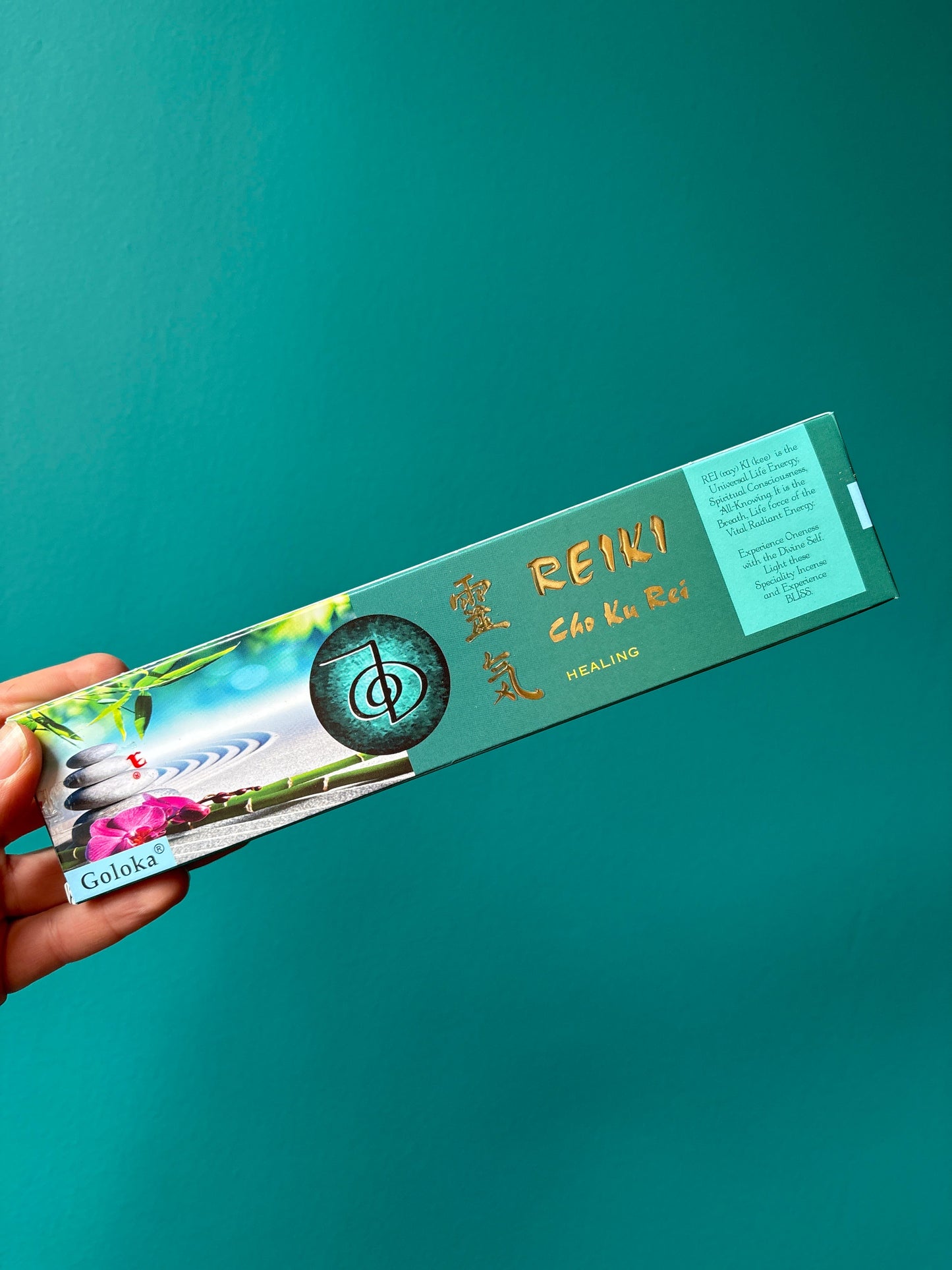 Goloka incense Reiki Cho Ku Rei healing incense sticks packaging held against teal background