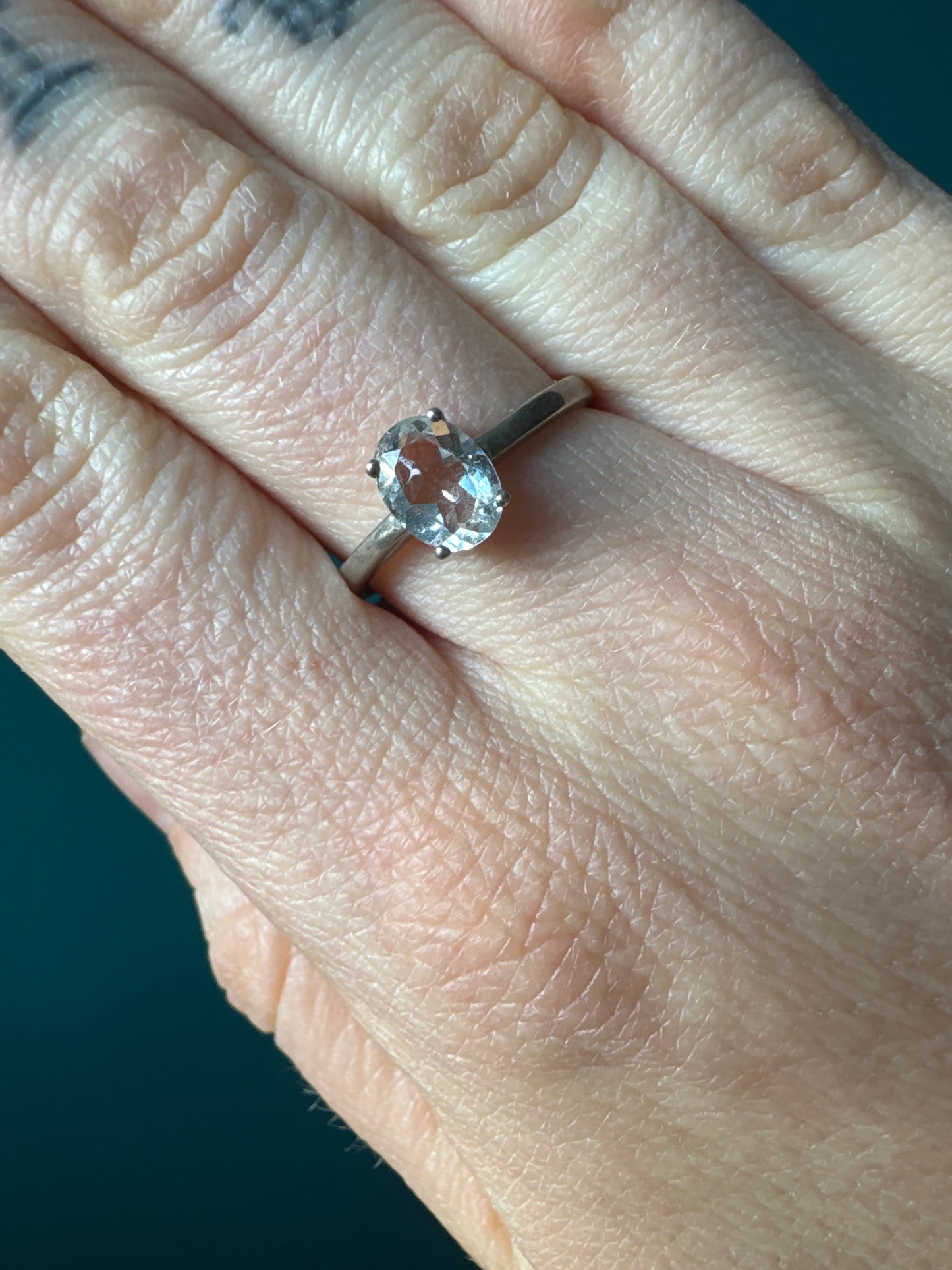 Ring Quartz Crystal Size 10 with clear oval quartz stone set on silver band worn on finger