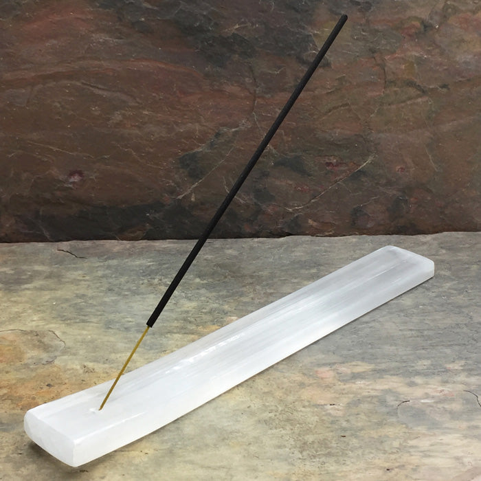 9-inch Selenite Incense Holder with a black incense stick on a stone surface