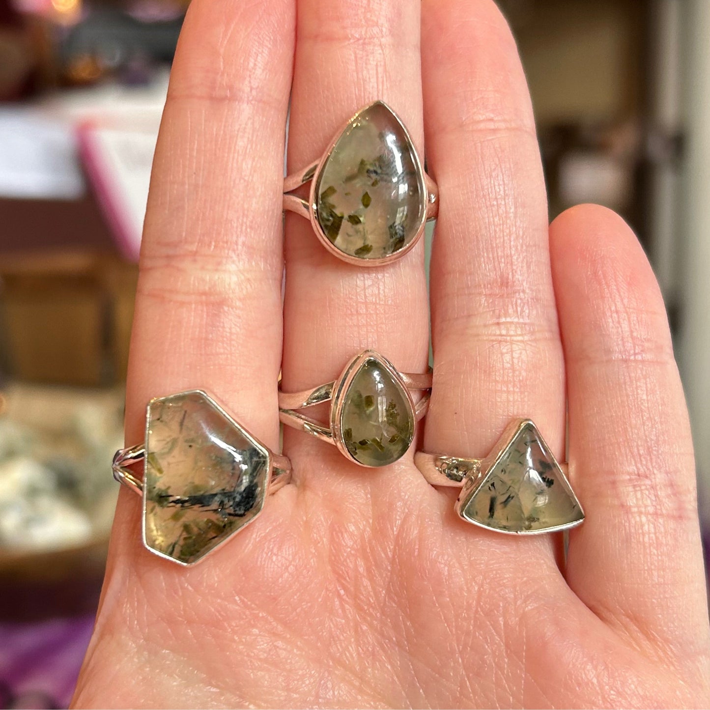 Ring Prehnite with natural green crystal formations set in silver bands displayed on hand