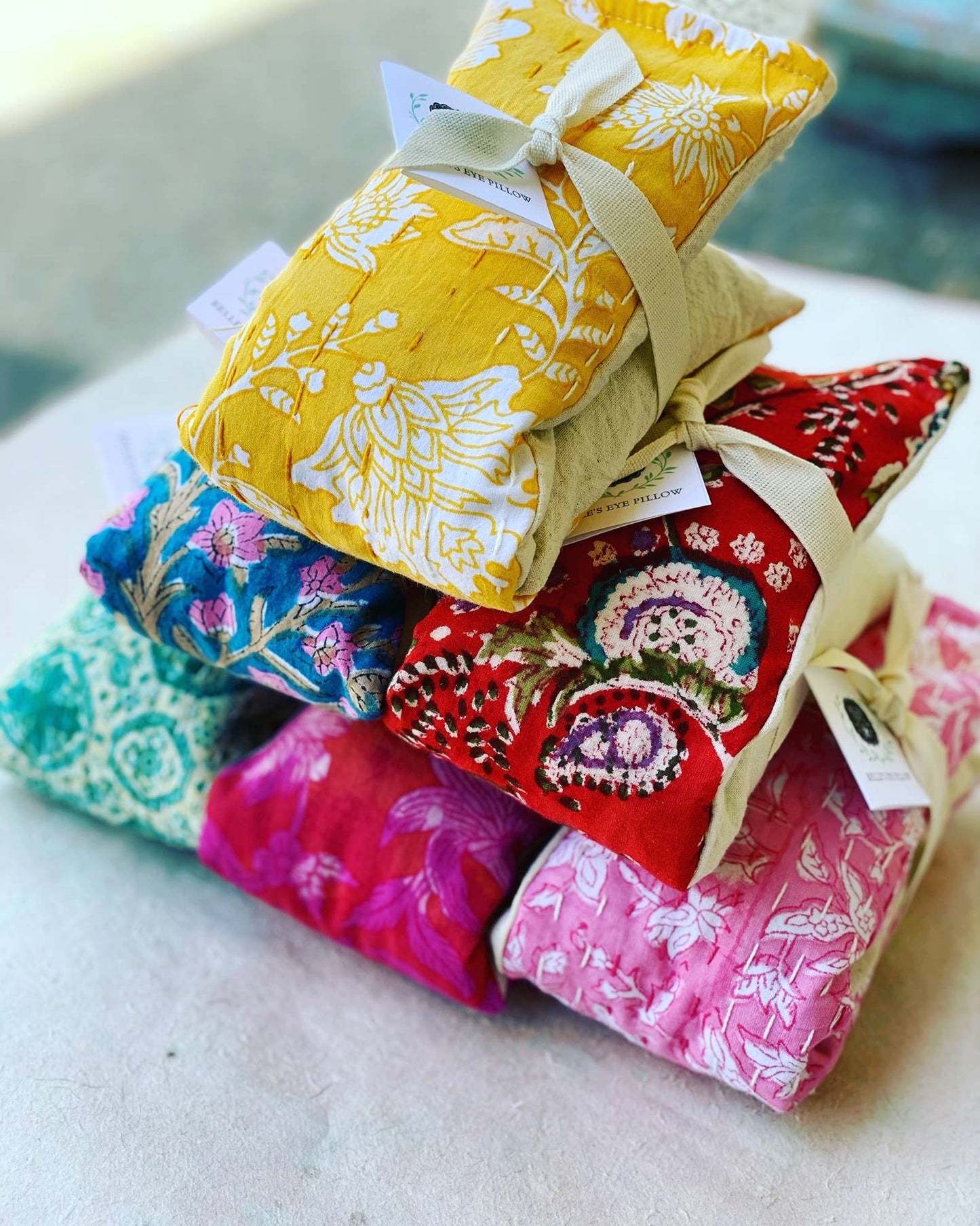 assortment of colorful lavender eye pillows with washable covers stacked together