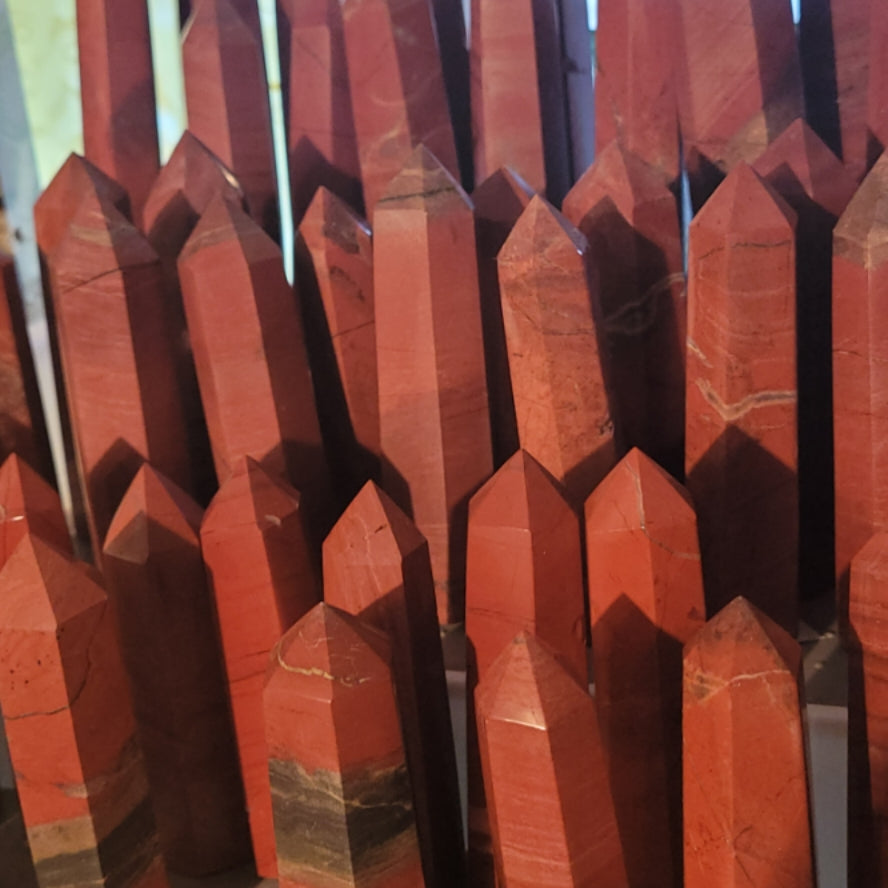 Collection of polished Brecciated Jasper Tower crystals with reddish and brown hues