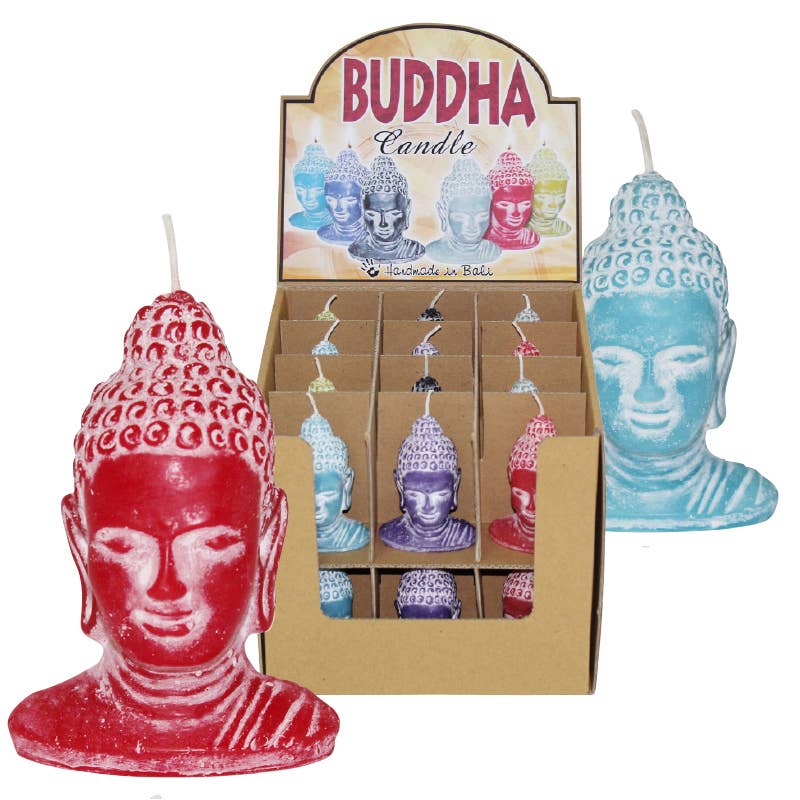 Assorted Buddha candles shaped as colorful Buddha heads including red, blue, and purple colors displayed in a cardboard box