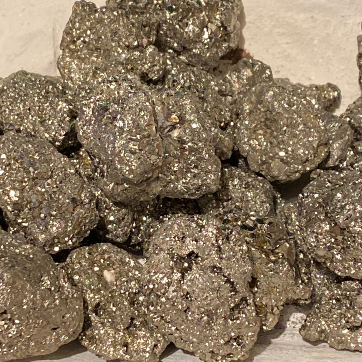 Cluster of raw pyrite pebbles with natural golden metallic shine for decor and positive energy