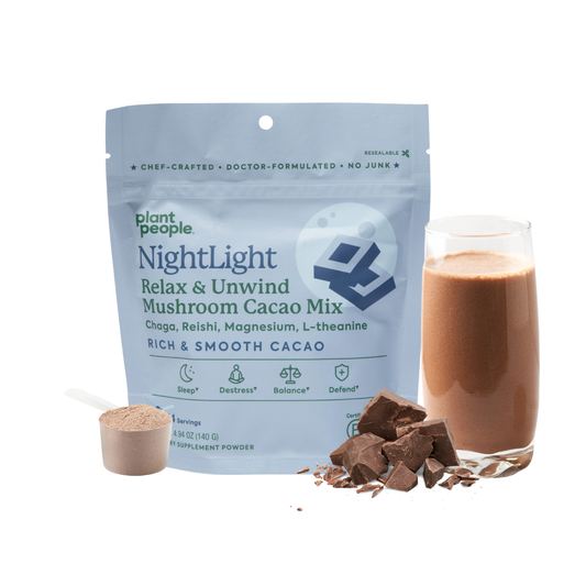 NightLight Calming & Chill Mushroom Cacao Mix pouch with scoop, chocolate chunks, and prepared cacao drink for relaxation and sleep support.