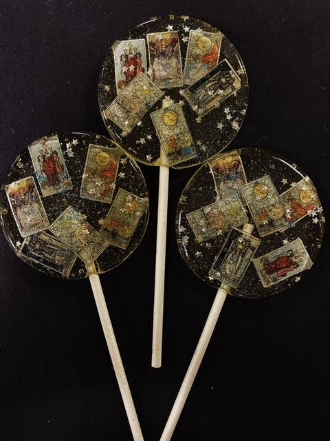 Handmade blackberry pear flavored Mystical Tarot Card Lollipops with vintage edible tarot card wafers and edible glitter stars, about 3 inches round.