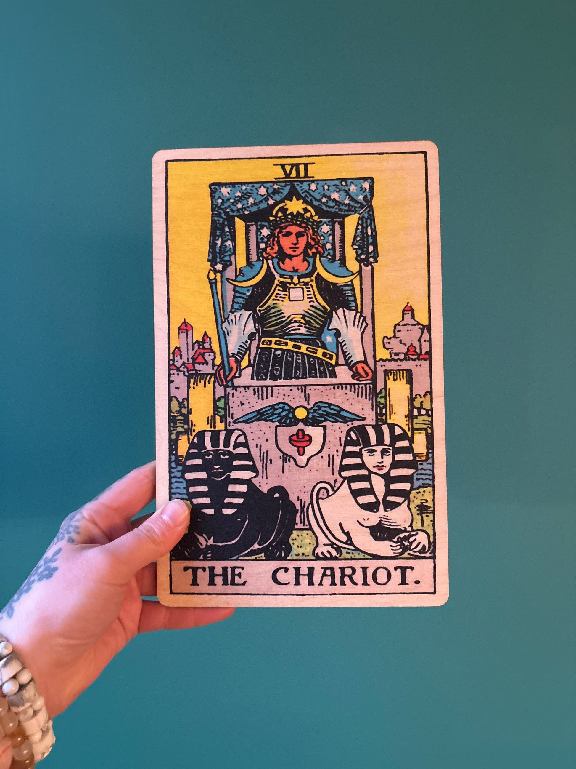 Wood Wall Art Tarot 7 Chariot card design held against teal background