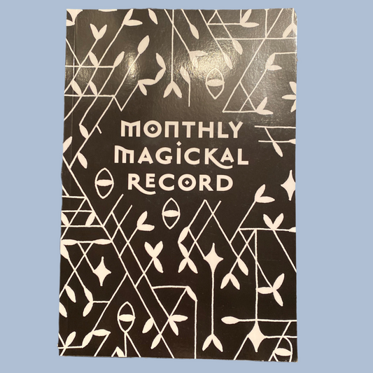 Monthly Magickal Record journal with black cover and white mystical abstract design
