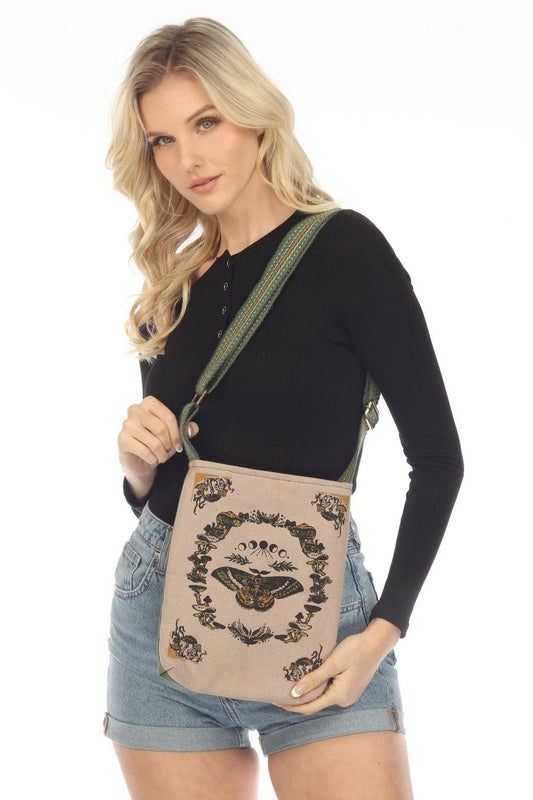 Moth Boho Shoulder Bag made of 100% cotton with adjustable strap worn by woman in black top and denim shorts