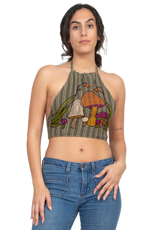 Woman wearing mushroom embroidery halter top with loose silhouette and striped pattern paired with blue jeans