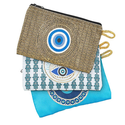 Assorted evil eye coin purses with intricate global-inspired designs and zippers