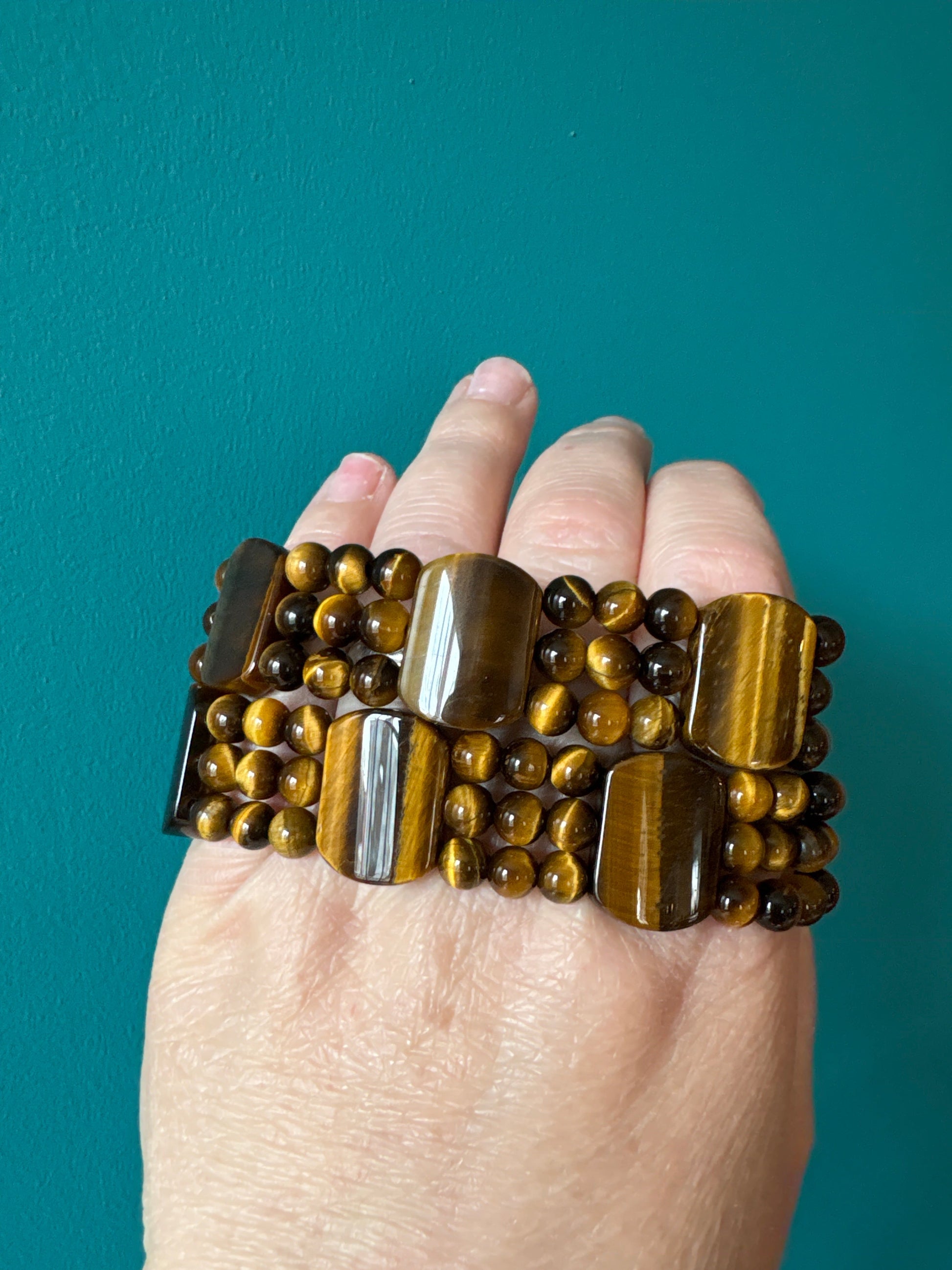 Three-row tiger’s eye bracelet with polished rectangular and round beads promoting courage and strength