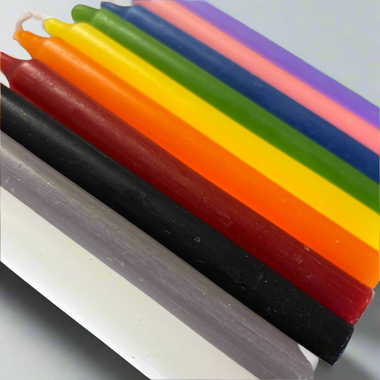 Colorful spell candles in various shades including white, gray, black, red, orange, yellow, green, blue, pink, and purple