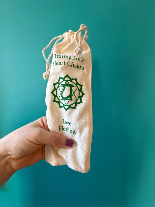 Heart Chakra Tuning Fork in beige pouch with green chakra symbol and text for healing and love