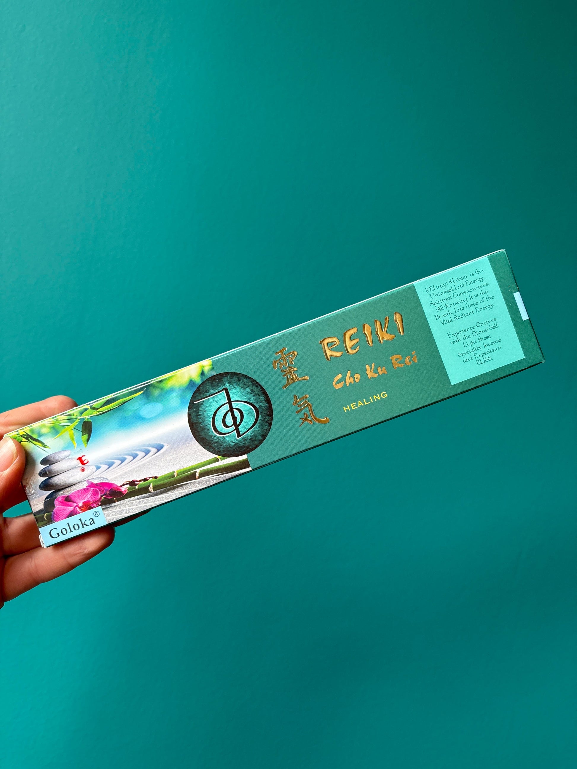 Goloka incense Reiki Cho Ku Rei healing incense sticks packaging held against teal background