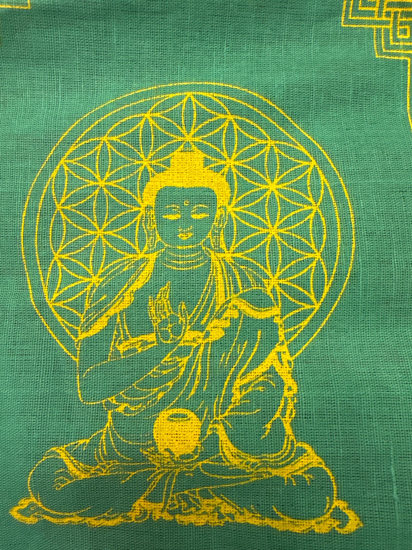 Green Buddha prayer flag with yellow Buddha illustration and geometric halo design