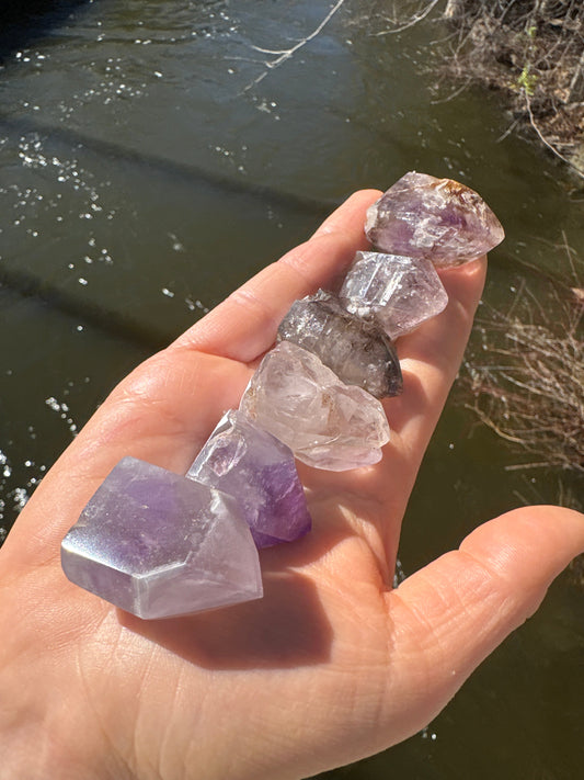 Mini amethyst point polished with natural inclusions, about 1 inch tall for travel and stress relief