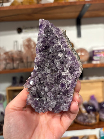 Large natural amethyst cluster with purple crystals promoting calm and spiritual awareness