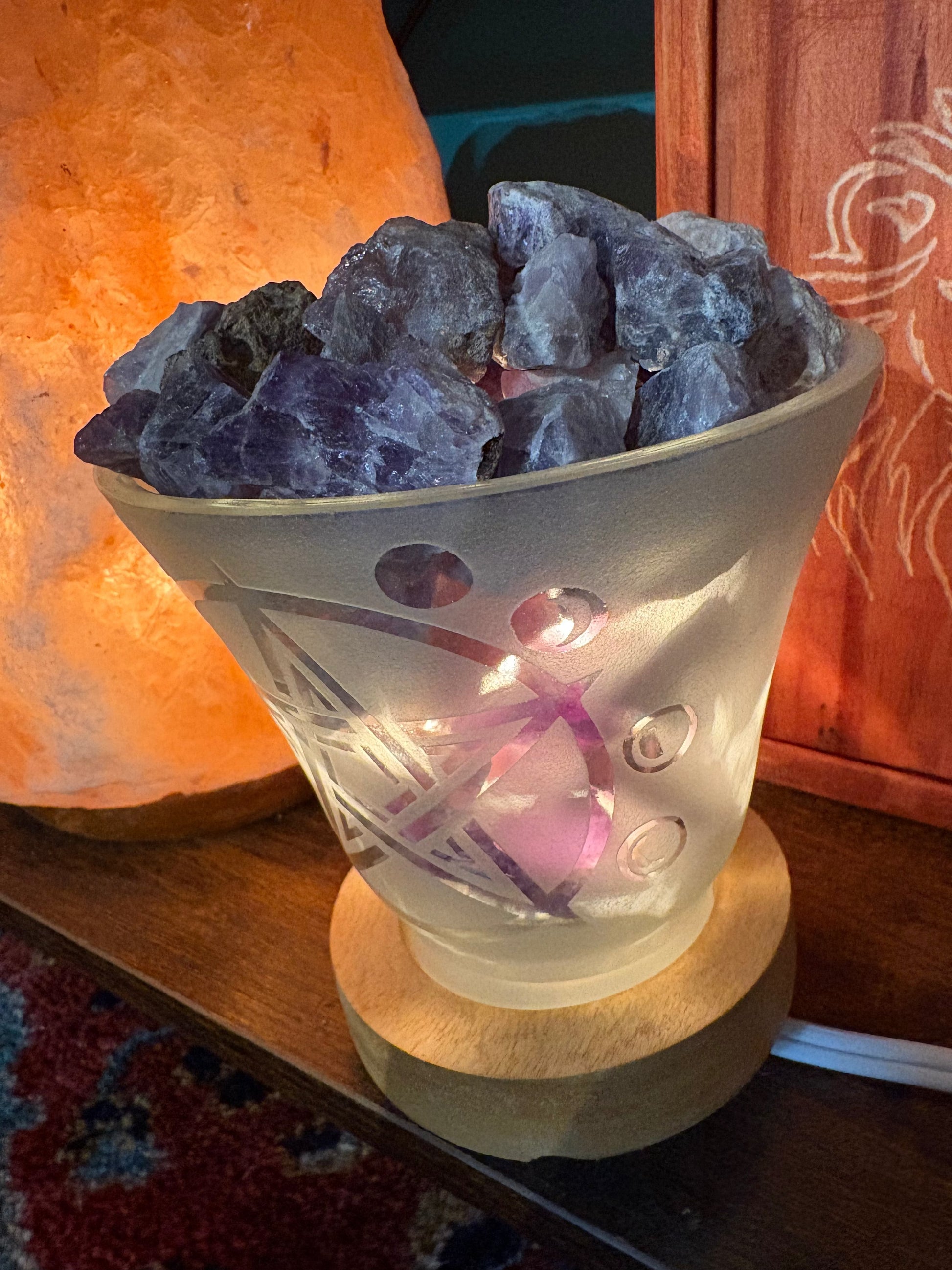 Amethyst crystal lamp with frosted glass, pentacle, and moon cycle design emitting calming ambient light