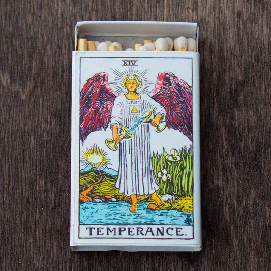 Tarot matchbox featuring the Temperance card design with matches inside on a wooden surface