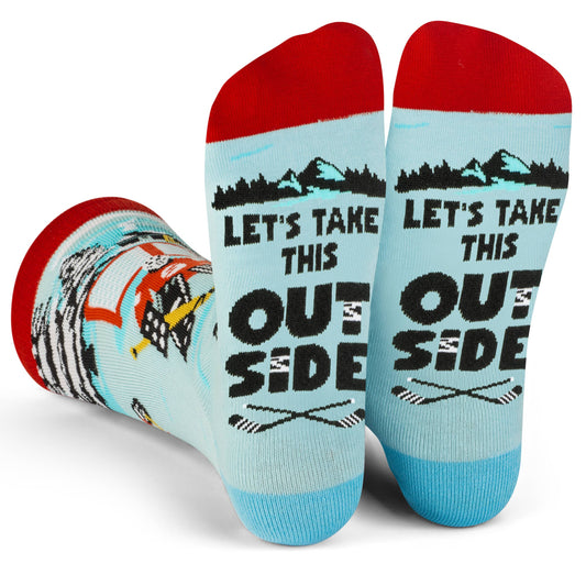 Crew length hockey socks with vibrant pond hockey scene and "Let's Take This Outside" message on the soles, red and blue accents.