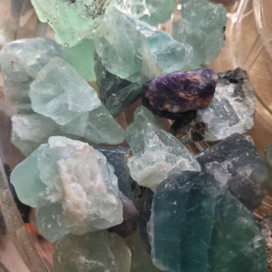 Raw Fluorite chunks in various light green and purple shades, 1 to 3 inches in size, natural rough texture