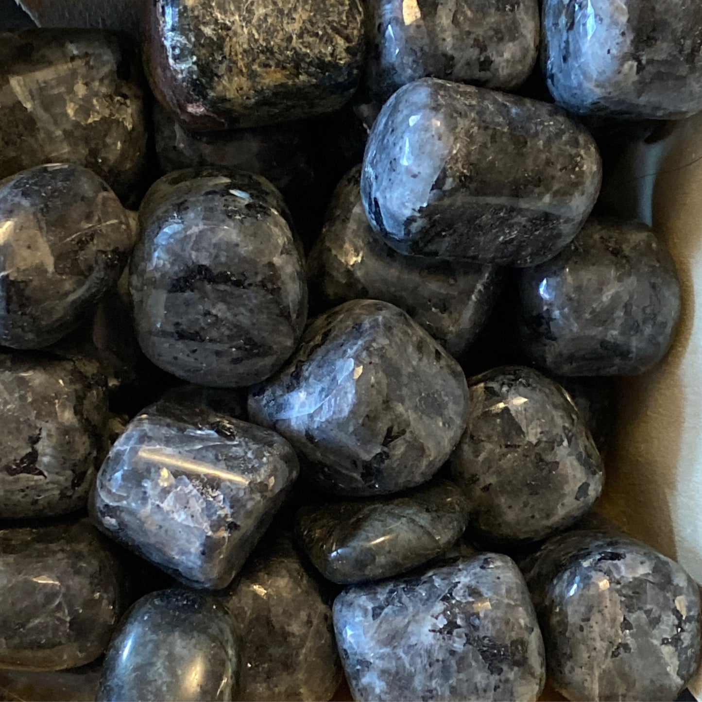 Polished larvakite tumbles with iridescent gray and black surfaces providing grounding energy and mental clarity