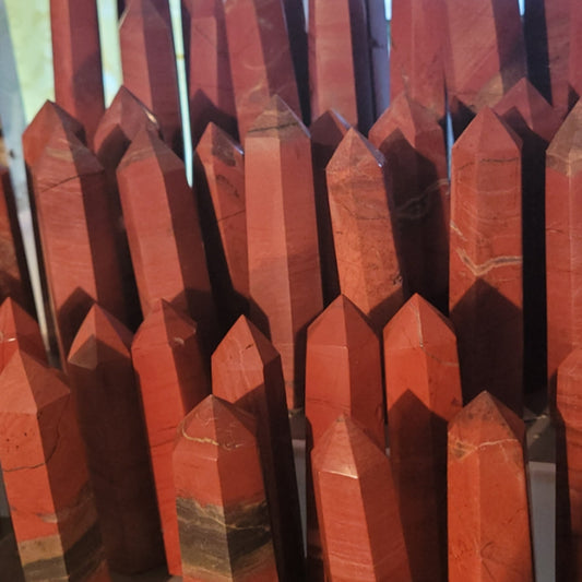 Collection of polished Brecciated Jasper Tower crystals with reddish and brown hues