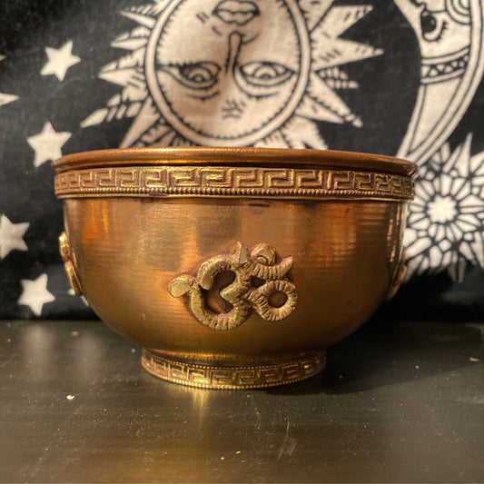 Copper Om Offering Bowl with intricate design and embossed Om symbol against a celestial background