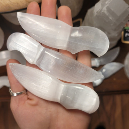 hand holding three 10cm mini selenite athames for spiritual rituals and meditation