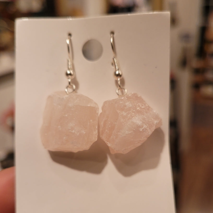 Raw rose quartz earrings with natural rough crystal stones on silver hooks displayed on white card