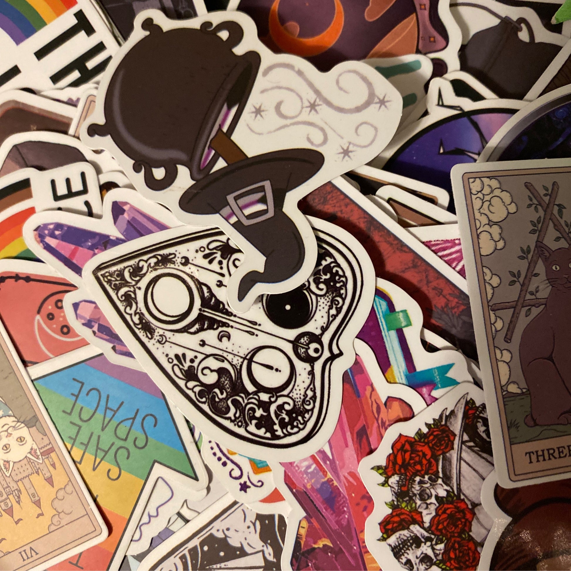 $3 Sticker with various colorful and artistic designs including tarot cards, roses, and vintage steam elements stacked together