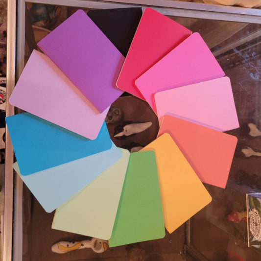 Colorful array of intuitive pocket journals arranged in a circle on a glass table