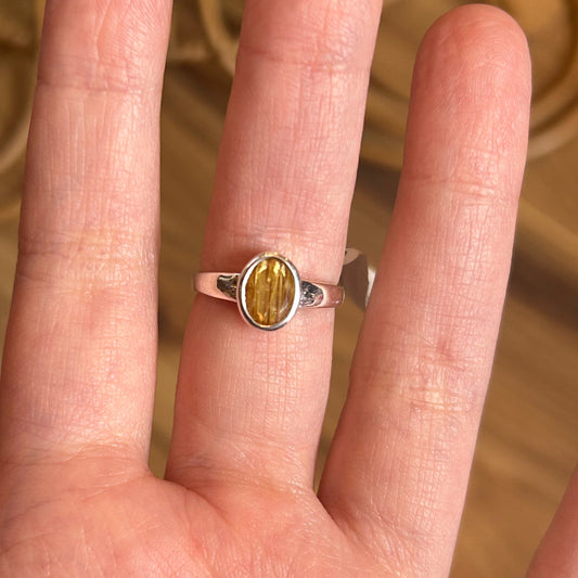 Ring Golden Rutile size 6 on finger with oval golden rutile stone set in silver band