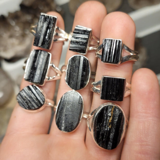 multiple Ring Raw Black Tourmaline with raw black tourmaline stones on silver bands displayed on fingers