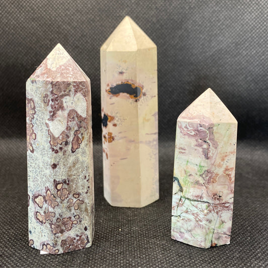 Picture Jasper Tower stones with unique natural patterns and polished pointed tips on a black background