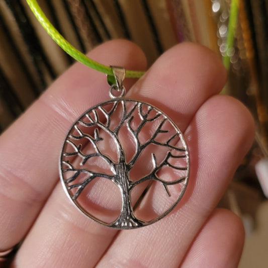 Sterling silver Tree of Life pendant on green cord symbolizing strength and growth