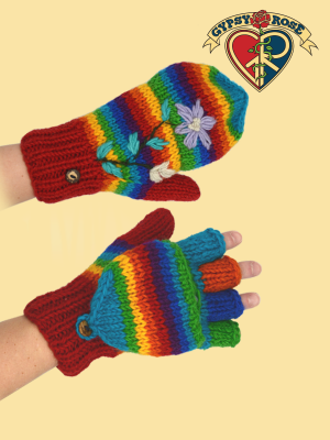 Colorful knitted glittens with rainbow stripes and floral embroidery on a yellow background