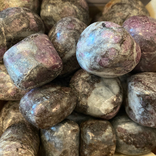  polished astrophyllite tumble stones with deep red garnet inclusions