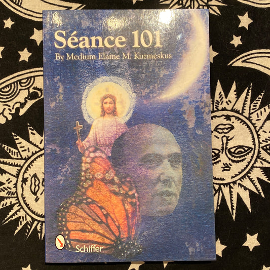 Book cover of Séance 101 by Medium Elaine M. Kuzmeskus featuring a mystical blue background with a monarch butterfly, a human face, and a glowing figure holding a cross under a crescent moon