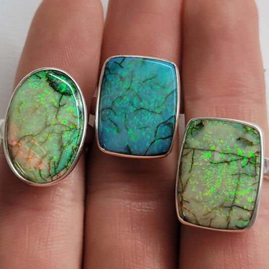 adjustable sterling silver ring with vibrant opal stone showcasing green and blue hues and healing properties