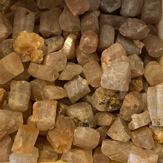 Close-up of raw golden apatite tumbles in natural untreated form