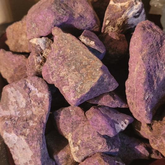 Raw Purpurite mineral stones with vibrant purple hues promoting peace and creativity